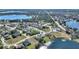 Aerial view of a house nestled in a quiet residential neighborhood near a lake at 206 Clovis Pass, Winter Haven, FL 33880