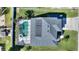 Aerial view showing house, pool, solar panels and driveway at 206 Clovis Pass, Winter Haven, FL 33880