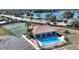 Aerial view of community pool, tennis courts, playground, and lake access at 206 Clovis Pass, Winter Haven, FL 33880