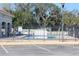 Community pool with surrounding fence and parking at 206 Clovis Pass, Winter Haven, FL 33880