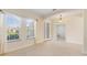 Bright and spacious entryway with tile flooring and elegant light fixture at 206 Clovis Pass, Winter Haven, FL 33880