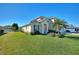 Two-story house with blue shutters, a palm tree, and a spacious yard at 206 Clovis Pass, Winter Haven, FL 33880