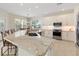 Modern kitchen with stainless steel appliances and white cabinets at 206 Clovis Pass, Winter Haven, FL 33880
