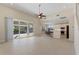 Open living room with high ceilings, tile floors, and access to the pool at 206 Clovis Pass, Winter Haven, FL 33880