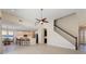 Open living area with high ceilings, a ceiling fan, and staircase at 206 Clovis Pass, Winter Haven, FL 33880