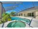 Lush landscaping surrounds the pool and spa at 206 Clovis Pass, Winter Haven, FL 33880