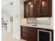 Wet bar with glass-front cabinets and a beverage fridge at 206 Clovis Pass, Winter Haven, FL 33880