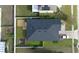 Aerial view of a well-maintained property featuring a dark roof and a fenced backyard at 1109 Brenton Manor Dr, Winter Haven, FL 33881