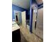 En-suite bathroom featuring double sink vanity, white tub and glass enclosed shower at 1109 Brenton Manor Dr, Winter Haven, FL 33881