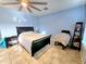 Bedroom with tile floors, ceiling fan and black wood bedroom furniture at 1109 Brenton Manor Dr, Winter Haven, FL 33881