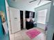 Cozy bedroom with a window, closet, dresser, and pink rug at 1109 Brenton Manor Dr, Winter Haven, FL 33881