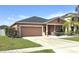 Charming single Gathering home with neutral tones, well maintained lawn, and an attached two-car garage at 1109 Brenton Manor Dr, Winter Haven, FL 33881