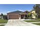Charming single Gathering home with neutral tones, well maintained lawn, and an attached two-car garage at 1109 Brenton Manor Dr, Winter Haven, FL 33881