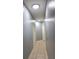 Bright hallway with tile flooring and multiple doors, illuminated by overhead lighting at 1109 Brenton Manor Dr, Winter Haven, FL 33881