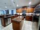 Well-lit kitchen with stainless steel appliances, granite counters, and large center island at 1109 Brenton Manor Dr, Winter Haven, FL 33881