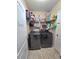 Compact laundry area with modern washer and dryer and ample shelving for storage at 1109 Brenton Manor Dr, Winter Haven, FL 33881