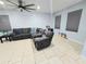 Spacious living room featuring ceramic tile flooring, large windows, and a comfortable sectional sofa at 1109 Brenton Manor Dr, Winter Haven, FL 33881