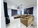 Spacious living room features a large sectional sofa, tile flooring and dark curtains at 1109 Brenton Manor Dr, Winter Haven, FL 33881