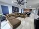 Open concept living room with a large brown couch and kitchen in the background at 1109 Brenton Manor Dr, Winter Haven, FL 33881