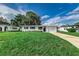 Charming single-story home with a well-manicured lawn and attached garage, set against a bright blue sky at 2350 E Washington St, Bartow, FL 33830