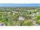 Aerial view showcasing a cozy home nestled within lush greenery in a tranquil neighborhood at 1705 Davis Ave, Bartow, FL 33830