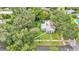 Birds-eye view of a home with a quaint yard shaded by mature trees in a residential area at 1705 Davis Ave, Bartow, FL 33830