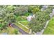 Overhead view of a charming home surrounded by lush trees in a peaceful neighborhood setting at 1705 Davis Ave, Bartow, FL 33830