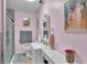 Bathroom featuring pink walls, a white vanity with a sink, and a glass-enclosed shower at 1705 Davis Ave, Bartow, FL 33830