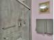 Shower stall with grab bars, gray tile, and glass door inside a pink bathroom at 1705 Davis Ave, Bartow, FL 33830
