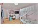 Cozy pink bedroom with a canopy bed, study desk, and ample shelving for storage at 1705 Davis Ave, Bartow, FL 33830