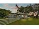 Charming single-story home with a red door and a white picket fence as dusk approaches at 1705 Davis Ave, Bartow, FL 33830