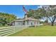 Charming single-story home with a red door and a white picket fence under a blue sky at 1705 Davis Ave, Bartow, FL 33830