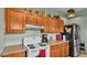 Practical kitchen with light cabinets, a white stove, and standard appliances for a cozy cooking space at 1705 Davis Ave, Bartow, FL 33830