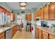 Functional kitchen with wooden cabinets, vintage appliances, and a doorway to the dining area at 1705 Davis Ave, Bartow, FL 33830