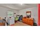 Bright laundry room with window, washing machine, and shelving for storage at 1705 Davis Ave, Bartow, FL 33830