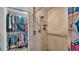 Walk in shower with a built-in shower caddy and closet with hanging clothes at 1705 Davis Ave, Bartow, FL 33830