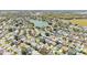 Aerial view of the houses, roadways, and lake in the surrounding neighborhood at 511 Alcazar Ct, The Villages, FL 32159