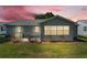 Backyard featuring grass, a fence, and a home with gray siding at 511 Alcazar Ct, The Villages, FL 32159