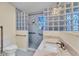 Updated bathroom with stylish glass block window and door with shower and modern fixtures at 511 Alcazar Ct, The Villages, FL 32159