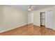 Bedroom featuring a spacious closet with wood floors, a ceiling fan, and an ensuite door at 511 Alcazar Ct, The Villages, FL 32159