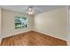 An empty bedroom with hardwood floors, a window, and a ceiling fan at 511 Alcazar Ct, The Villages, FL 32159