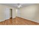 A bedroom with hardwood floors, an open door, and a double door closet at 511 Alcazar Ct, The Villages, FL 32159