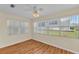 Bedroom with hardwood floors, fan, and large windows with blinds at 511 Alcazar Ct, The Villages, FL 32159