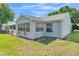 View of the home's siding with mulch and grass at 511 Alcazar Ct, The Villages, FL 32159