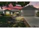 Charming single-story home featuring well-manicured landscaping and an attached two-car garage at 511 Alcazar Ct, The Villages, FL 32159