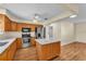 Open kitchen with stainless steel appliances, center island, and ample counter space at 511 Alcazar Ct, The Villages, FL 32159