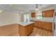 Kitchen with stainless steel appliances, center island, and seamless flow to the living spaces at 511 Alcazar Ct, The Villages, FL 32159