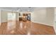 Bright open-concept living room featuring wood floors and an adjacent kitchen with island at 511 Alcazar Ct, The Villages, FL 32159