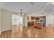 Spacious living room with hardwood flooring and a view into the kitchen area at 511 Alcazar Ct, The Villages, FL 32159