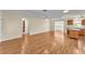 Expansive living area featuring wood floors, open layout, and seamless transition to the kitchen at 511 Alcazar Ct, The Villages, FL 32159